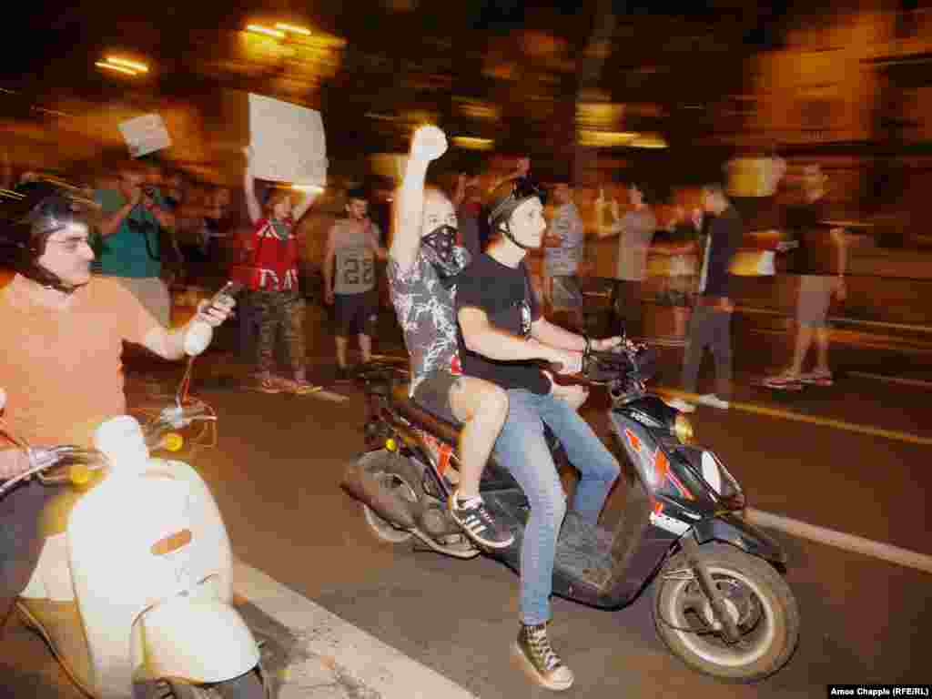 A group of young protesters on scooters during the short march. 