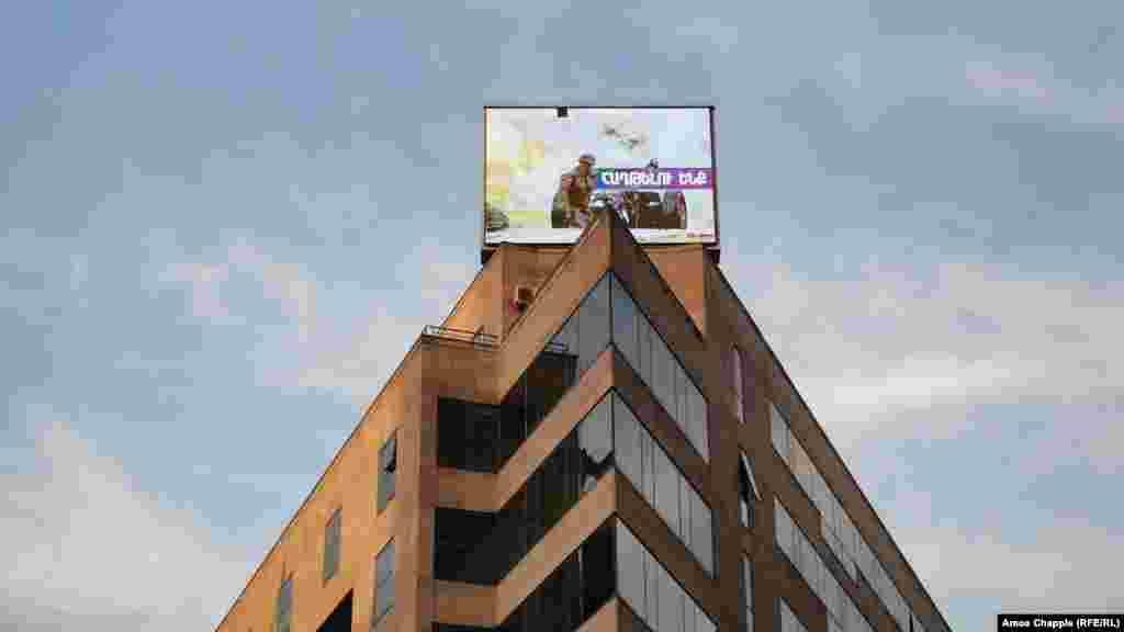 A photo of a now-deceased Armenian soldier is displayed on a building in central Yerevan on October 28. 