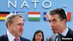 Ukrainian Foreign Minister Andriy Deshchytsya (left) listens to NATO Secretary-General Anders Fogh Rasmussen during a NATO-Ukraine foreign ministers meeting in Brussels on April 1.