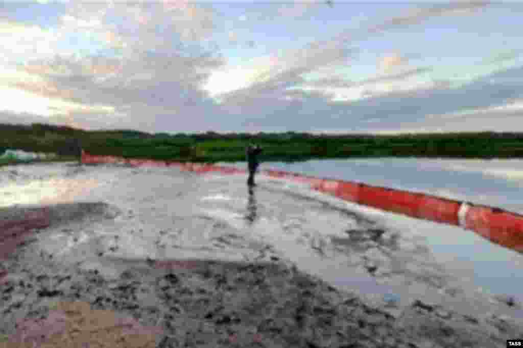 A containment boom at the site of the spill on July 13