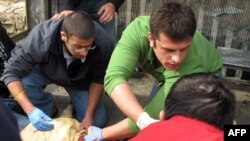 Paramedics rush to the aid of wounded man at the explosion near Jerusalem's Central Bus Station.