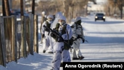 Law enforcement officers stand guard near a local school where a student with an ax attacked other pupils and a teacher in the Siberian city of Ulan-Ude on January 19.