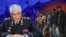 Коллаж: Колокольцев и мигранты