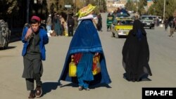 Afghans receive food aid distributed by the German government in Kabul. (file photo)