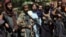 Taliban fighters pose for photograph in Kabul's Wazir Akbar Khan neighborhood on August 18.