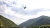An Abkhaz helicopter flies over the remote Kodori Gorge near the town of Chkhalta