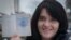 Anastasia Palazhanka brandishes her passport in an undated photo.