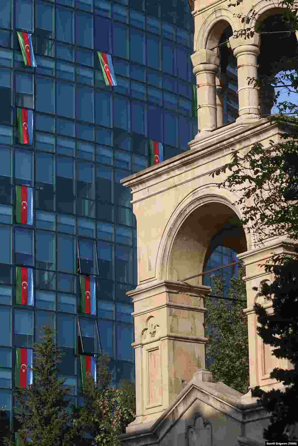 St. Gregory the Illuminator Church (right) and the offices of the International Bank of Azerbaijan are adorned with national flags on November 4. 
