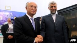 Iran's chief nuclear negotiator Said Jalili (right) with IAEA chief Yukiya Amano in Tehran on May 21.