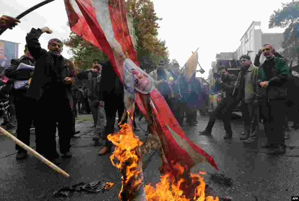 Iranians burn U.S. flags outside the former U.S. Embassy in Tehran on November 4, 2014.