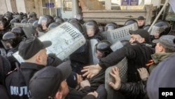 Pro-Russian protesters clash with police as they try to occupy a regional administration building in Donetsk earlier this week. Russian media are reporting that staff from a U.S. military contractor have been assisting Kyiv authorities in eastern Ukraine.