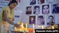 An Indian journalist lights candles during a vigil for Afghan journalists killed in a targeted earlier this year.